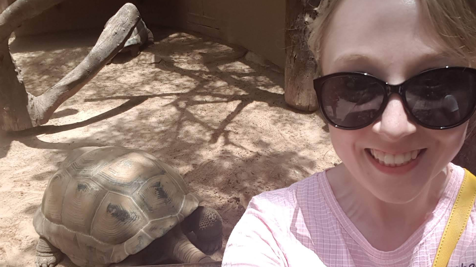 Me taking a selfie in front of a giant tortoise.