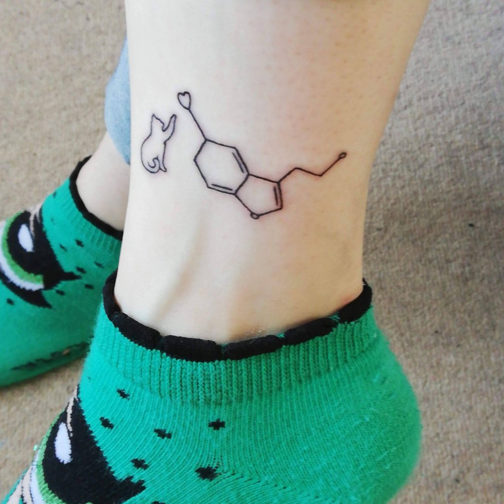 My First Tattoo - Serotonin symbol with cat pawing at it