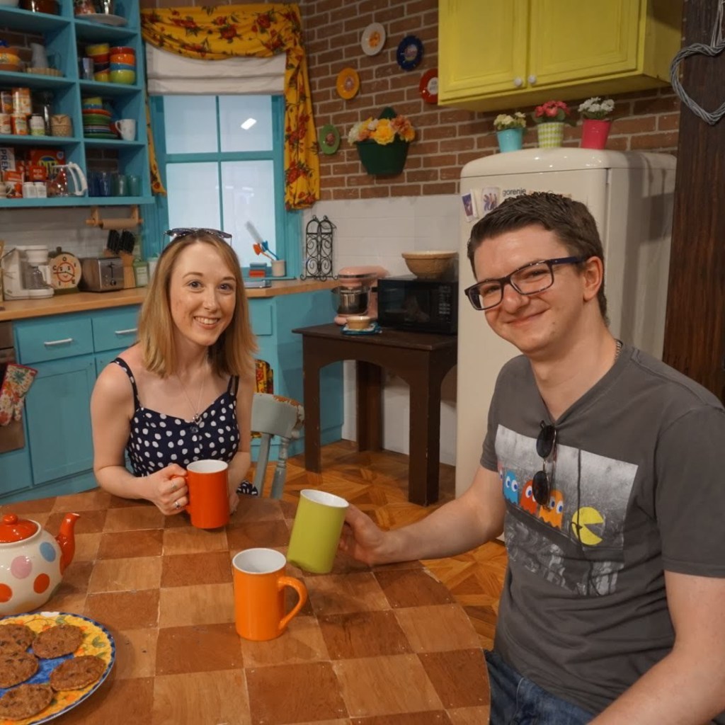 Liam and I posing with coffee cups in Monica's apartment