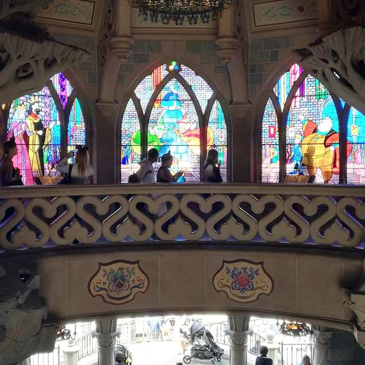 Photo of the colourful windows within the Sleeping Beauty castle.