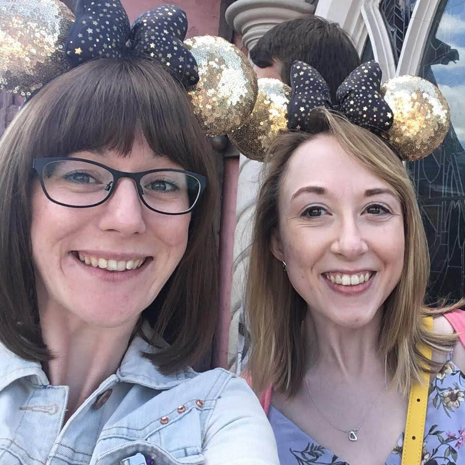 Lillie and I both smiling and wearing our gold sequin Mickey Mouse ears