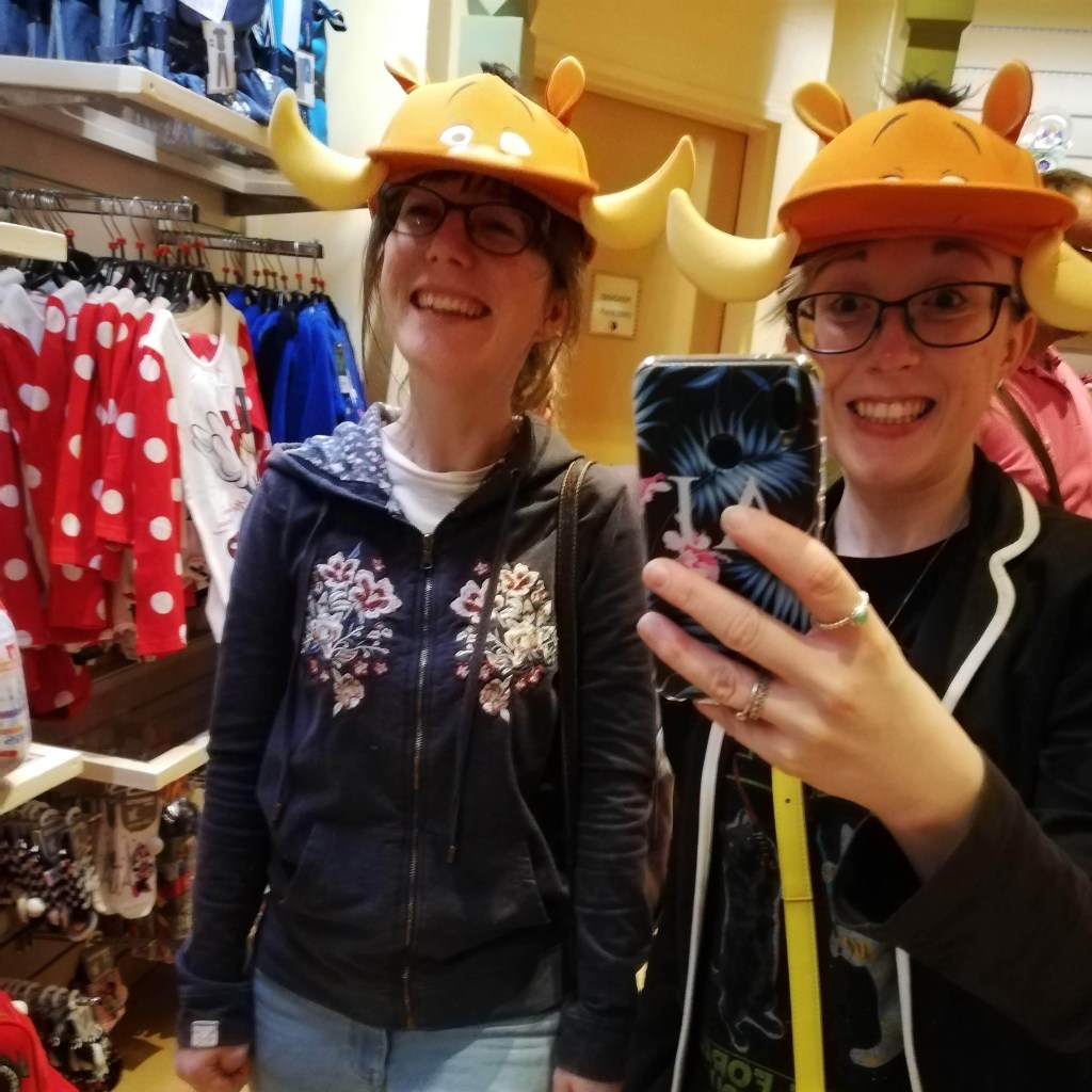 Lillie and I trying on Pumbaa hats in the gift shop - we're both smiling like idiots