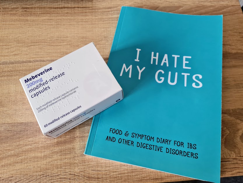 Photo of my box of Mebeverine next to the "I Hate My Guts" journal.