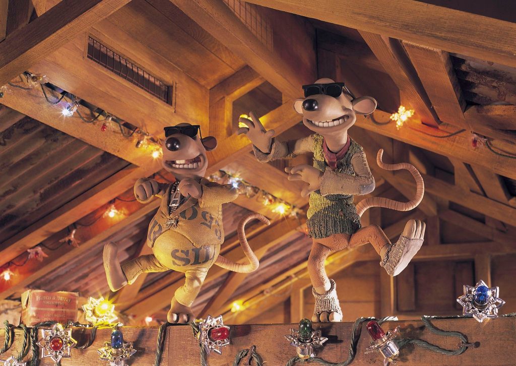 Nick and Fetcher dancing on one of the beams in the hut. They have decorated it with Christmas lights and are both wearing sunglasses in a similar style to the Blues Brothers.