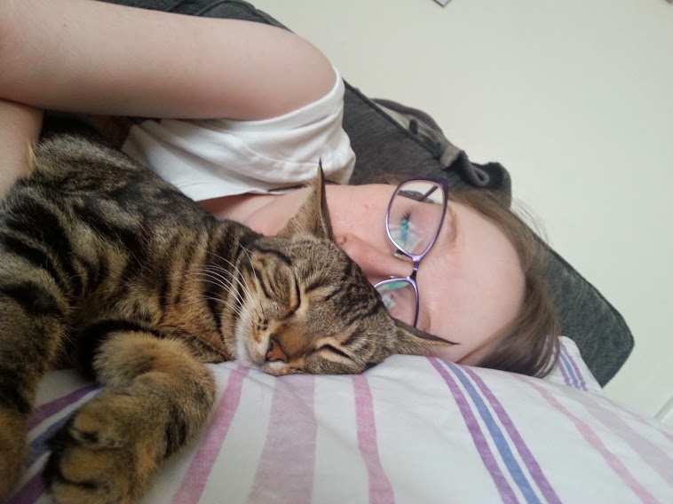 Tilly and me cuddled up together. We're both asleep.