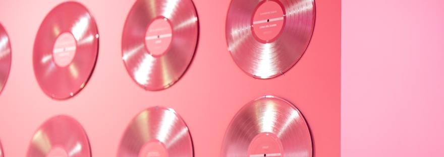 CDs Against Pink Background