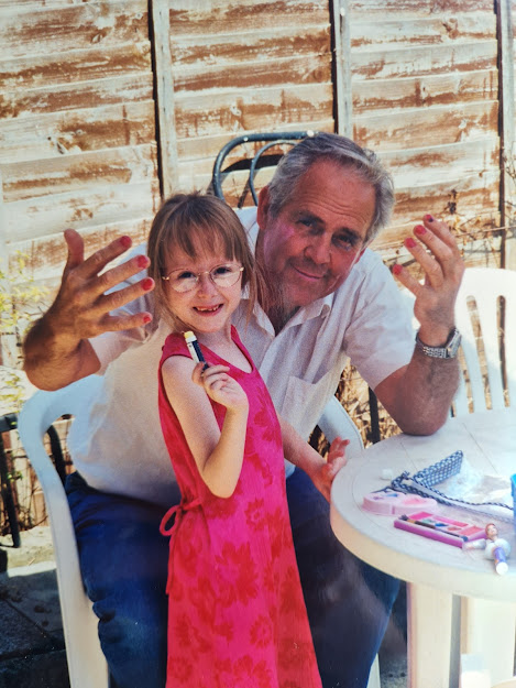 Me (age 7) with Terry. I have painted his nails and am smiling proudly while he smiles at the camera. 